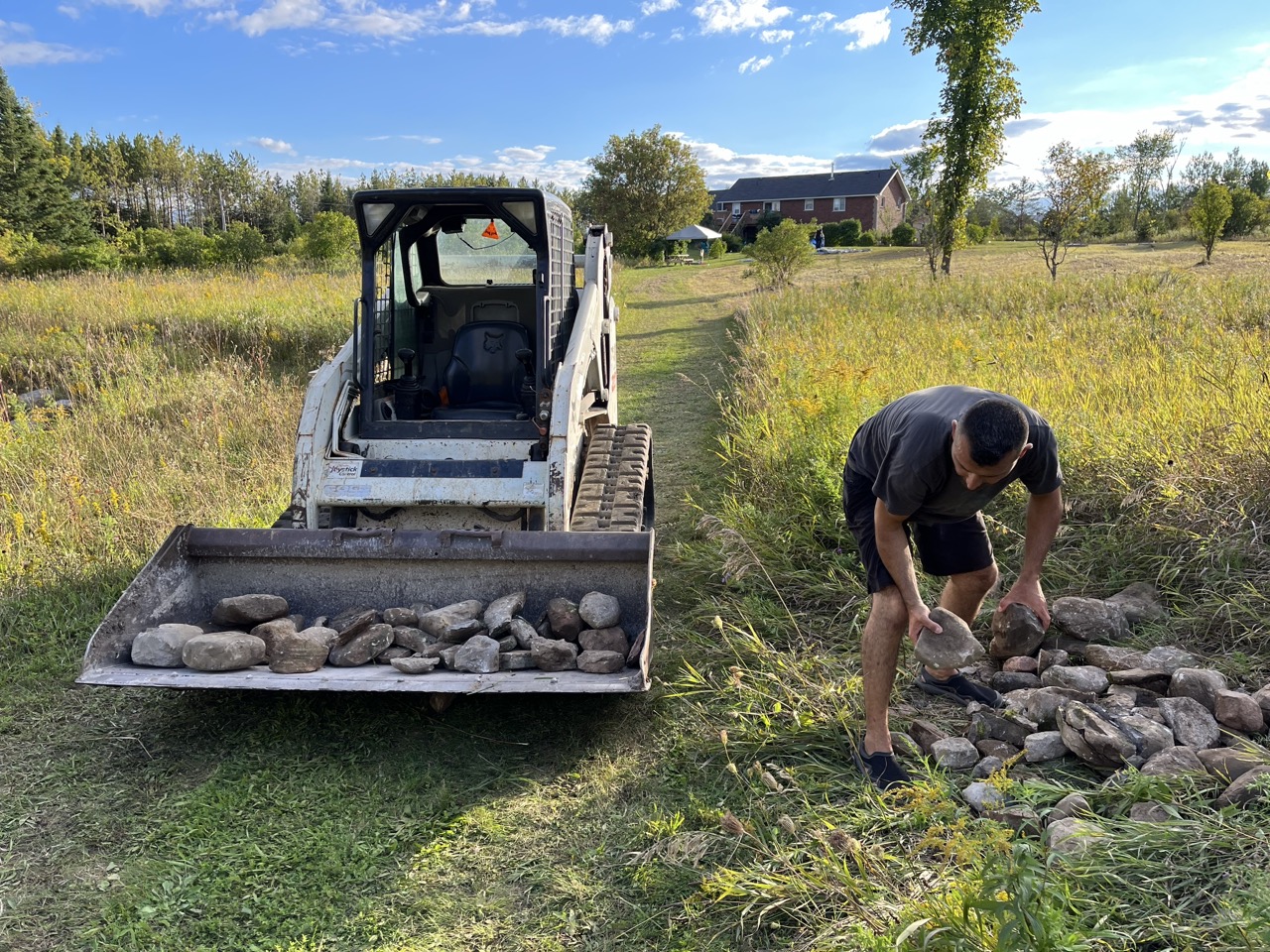 Landscape work with excavator — building stone features